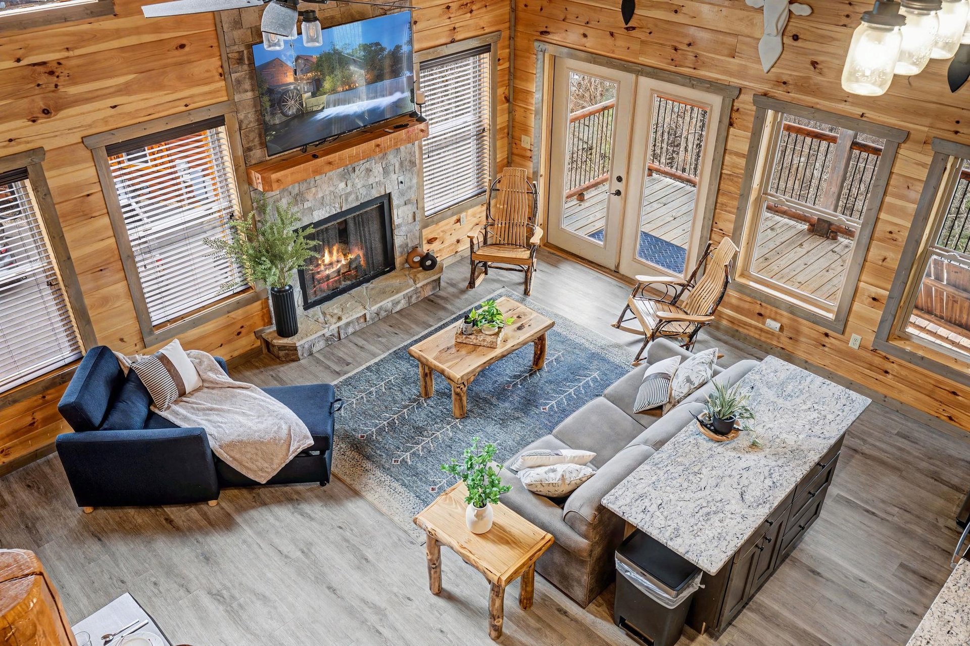 Unwind in your spacious living room with crackling fireplace, plush seating, and stunning deck views through floortoceiling windows.