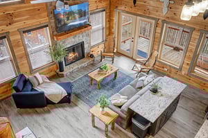 Unwind in your spacious living room with crackling fireplace, plush seating, and stunning deck views through floortoceiling windows.