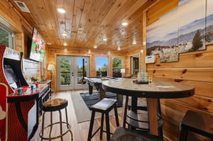 Challenge friends to pool or arcade games in this woodpaneled entertainment space, where floortoceiling windows frame scenic mountain views and invite natural light to fill your playful afternoons.