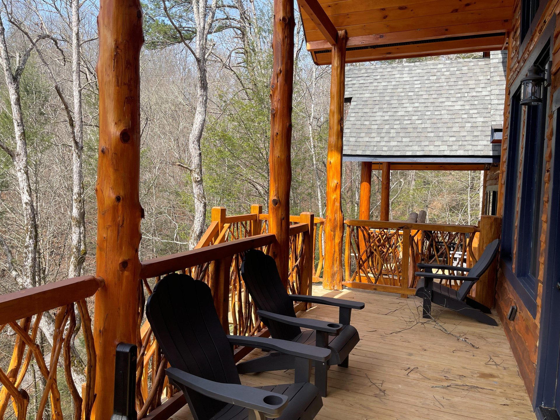 Sip your morning coffee while enjoying peaceful forest views from this expansive wraparound deck with comfortable seating.
