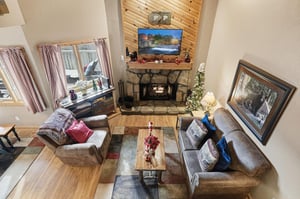 Cozy up in your mountain retreat living room, where a crackling fireplace and plush seating create the perfect atmosphere for relaxing evenings.