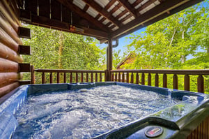 Sink into the bubbling hot tub on your private covered deck, surrounded by lush forest views that bring nature right to your doorstep.