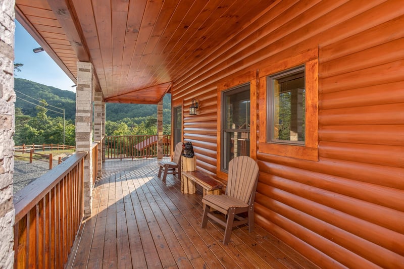 Porch with two chairs and a bench at Four Seasons Palace, a 5bedroom cabin rental located in Pigeon Forge