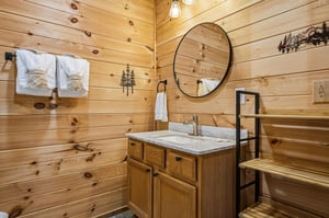 Warm wood paneling and rustic accents set the tone for your mountain retreat, with fresh towels waiting and a peaceful spot to freshen up after your days adventures.