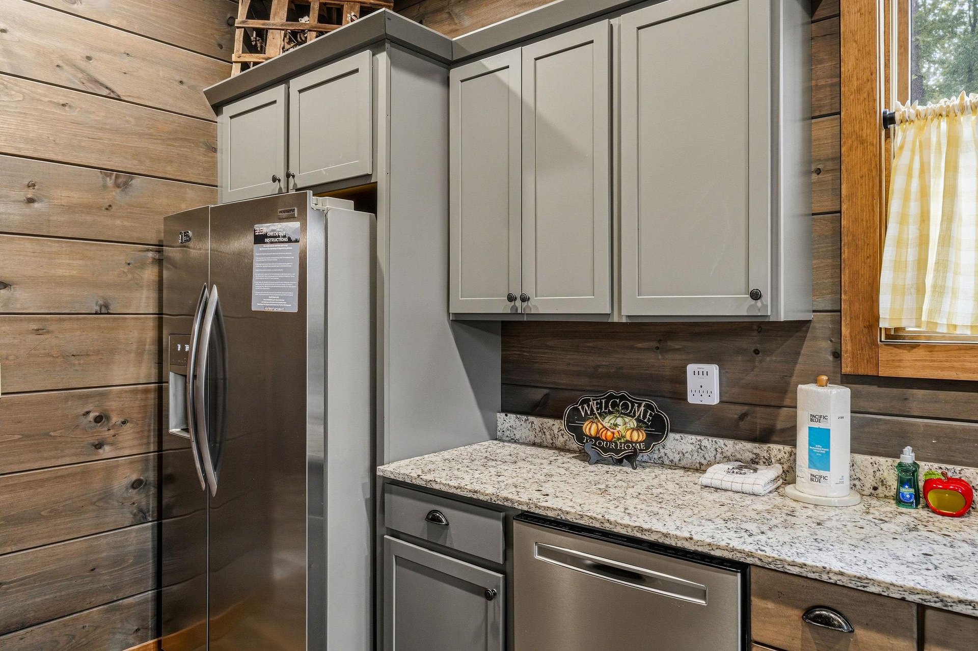 Step into a fullyequipped kitchen blending rustic charm and modern convenience. Gray cabinetry, granite counters, and stainlesssteel appliances make meal prep effortless in your home away from home.