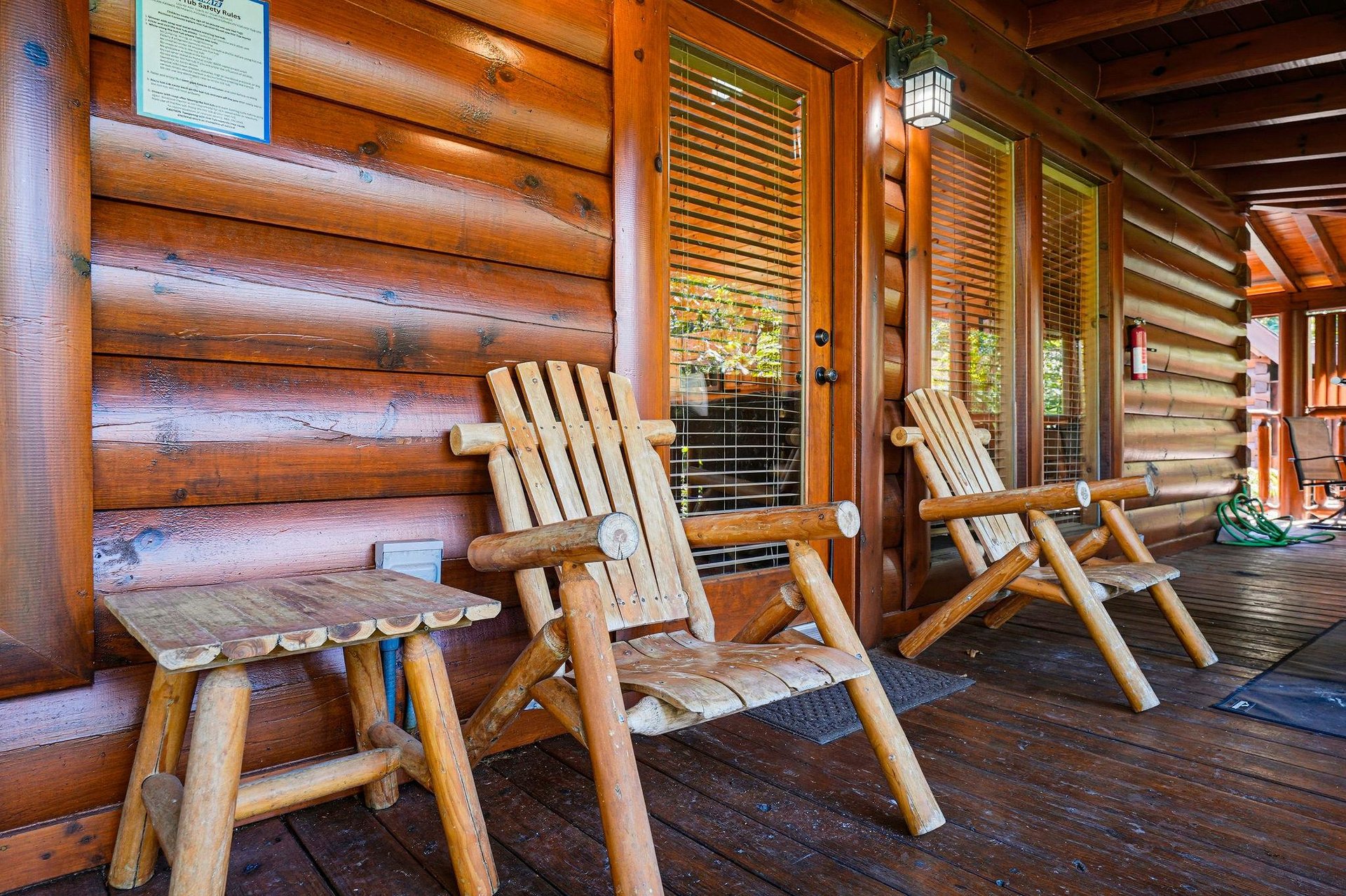 Relax on your private porch in handcrafted log chairs, where warm wood surrounds you and natural light filters through the trees. Unwind in rustic comfort and soak in the peaceful cabin atmosphere.