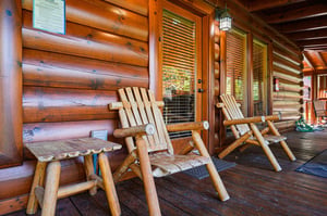 Relax on your private porch in handcrafted log chairs, where warm wood surrounds you and natural light filters through the trees. Unwind in rustic comfort and soak in the peaceful cabin atmosphere.