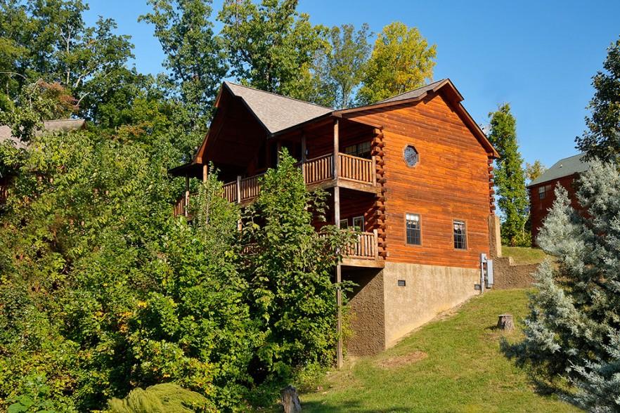 Looking back at the cabin with the trees in front at Kick Back  Relax A 4 bedroom cabin rental located in Pigeon Forge