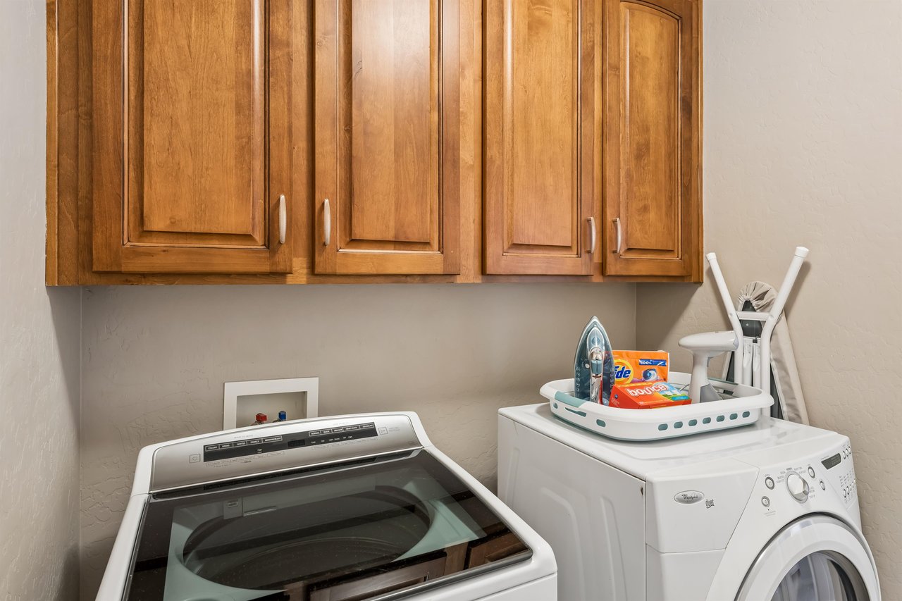 Washer, dryer, steamer, iron, and ironing board.