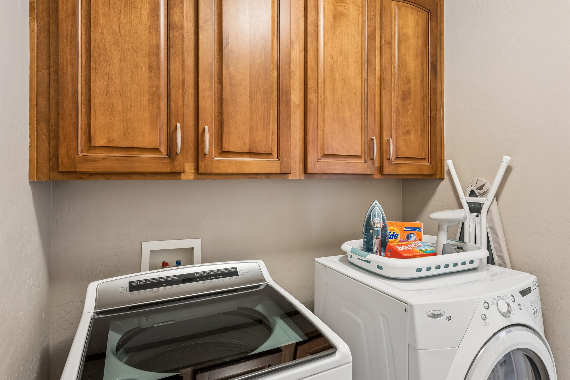 Washer, dryer, steamer, iron, and ironing board.