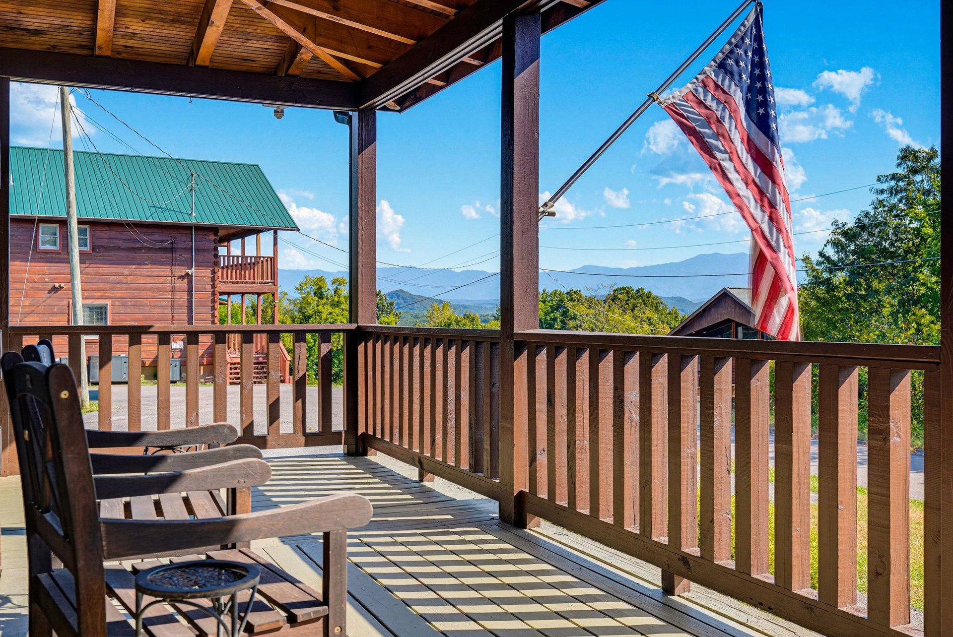 Step onto your private covered deck and soak in sweeping mountain vistas under clear blue skies. Two relaxing chairs invite you to unwind and breathe in the peaceful mountain air.