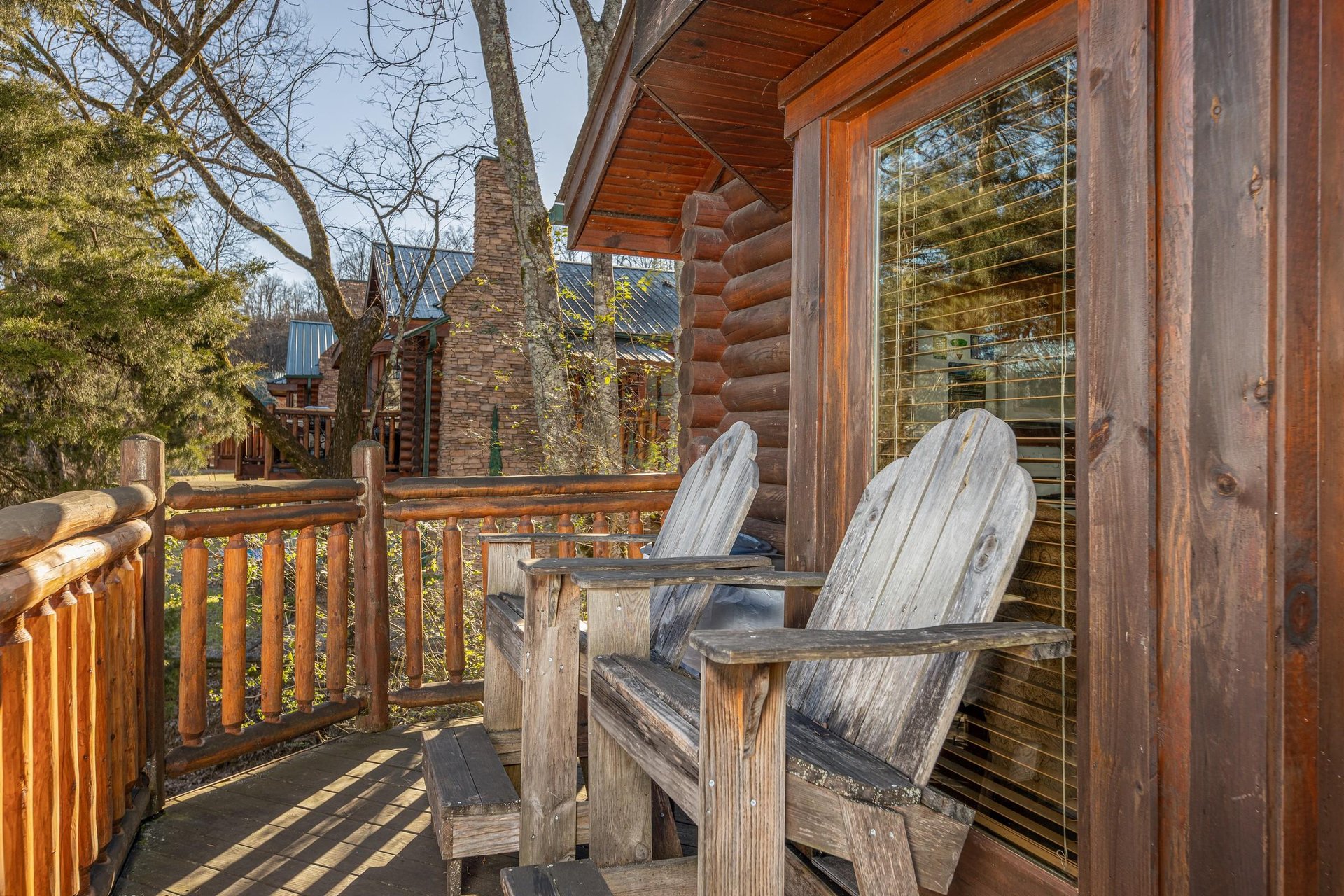 Adirondack chairs on a deck at Gone Fishin, a 2bedroom cabin rental located in Pigeon Forge