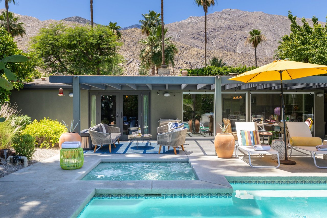 Entertainers backyard with outdoor seating, private pool and spa, sun loungers, cabana, and outdoor dining space.
