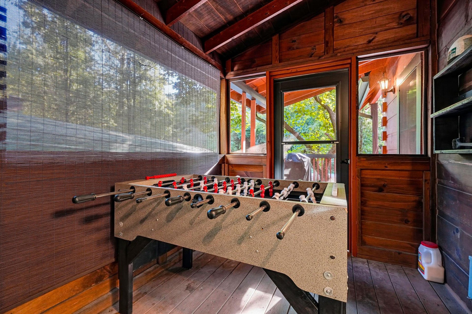 Challenge your friends to a game of foosball in this cozy cabin game room, where rich wood tones and mountain views create your perfect retreat.