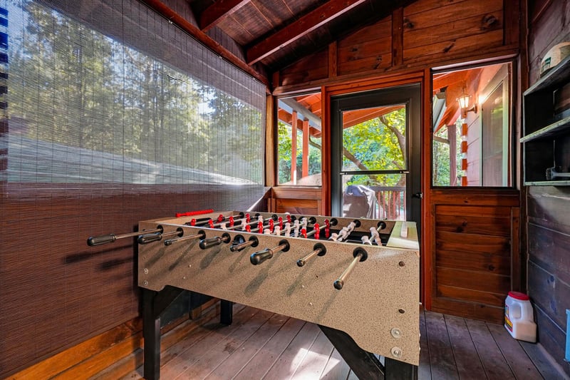 Challenge your friends to a game of foosball in this cozy cabin game room, where rich wood tones and mountain views create your perfect retreat.