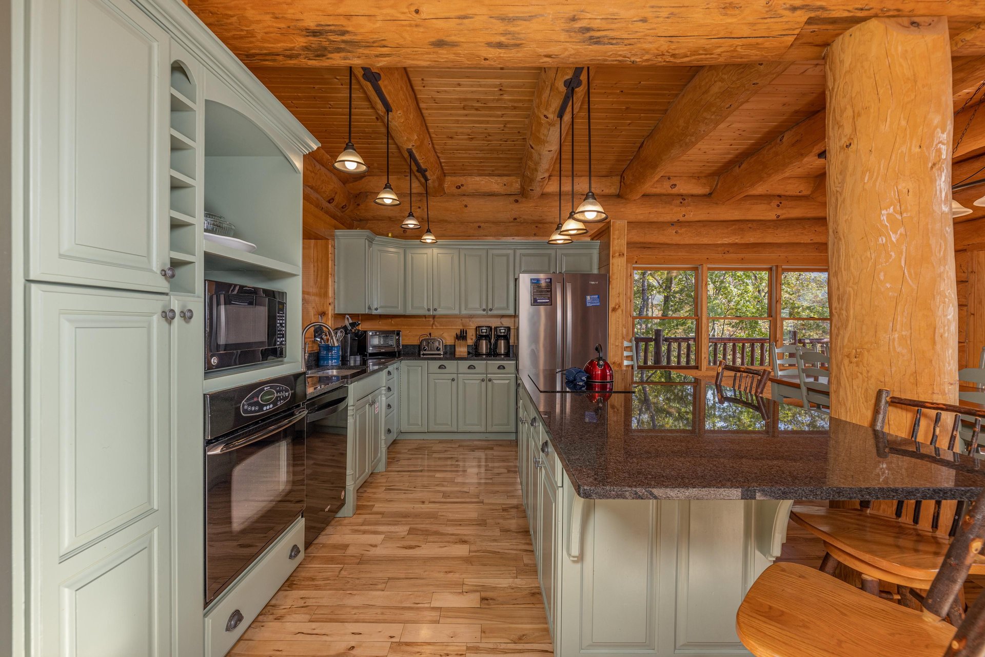 Full kitchen with island and green cabinets