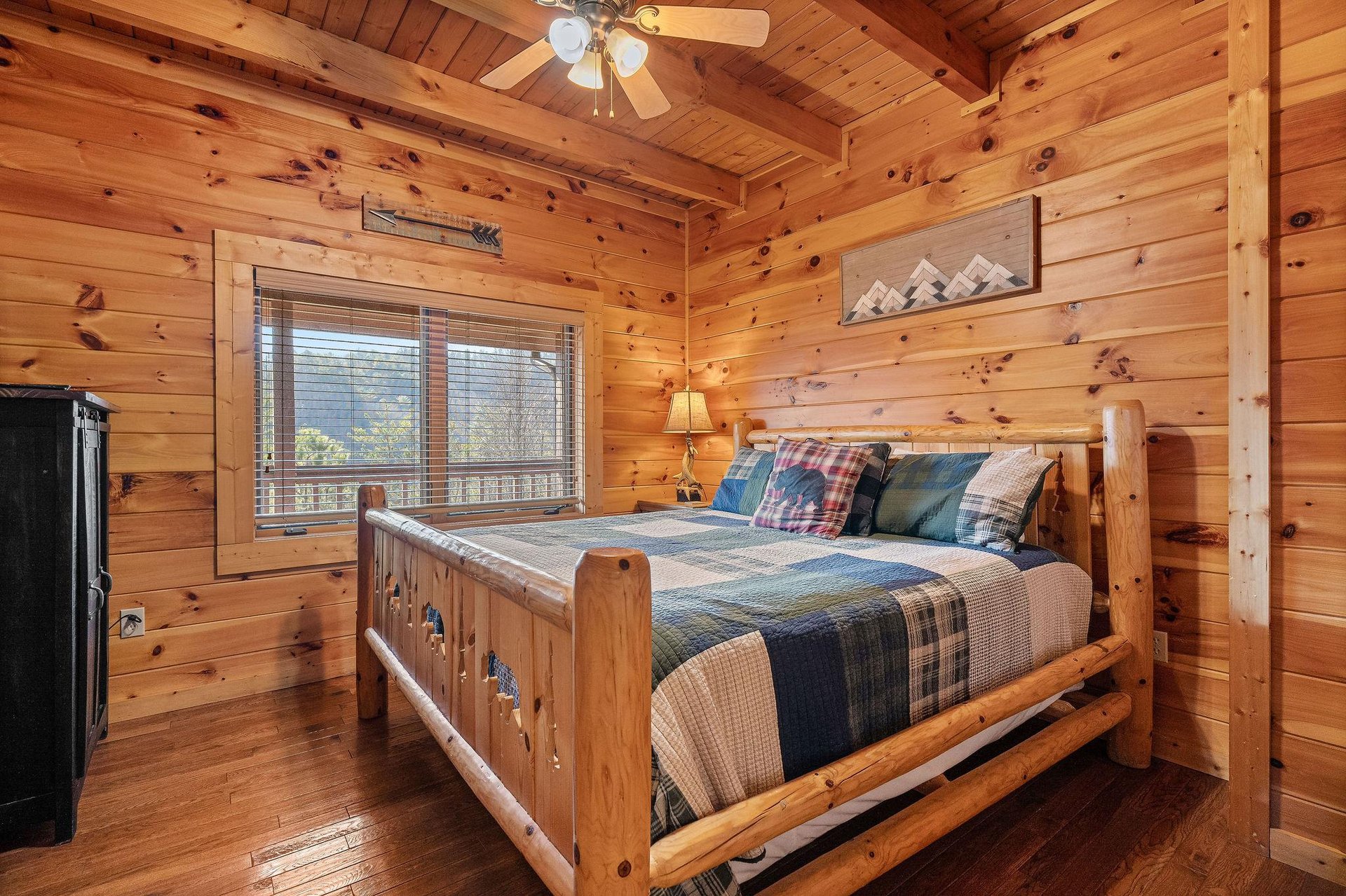 King bed and armoire with TV in a bedroom at Mountain Mama, a 3 bedroom cabin rental located in Pigeon Forge