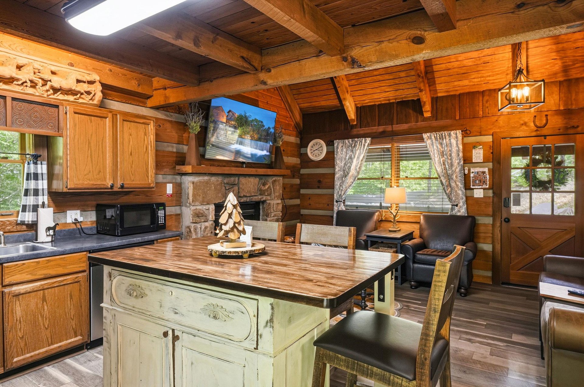 Step into your cozy log cabin retreat where rustic charm meets modern comfort. Warm wood surrounds you, from the handcrafted beams overhead to the stone fireplace inviting relaxation after your day of
