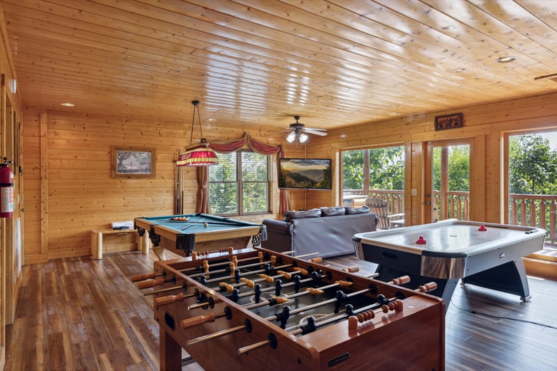 foosball, pool table, sofa, hocky table, and TV