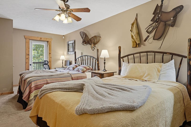 Rest easy in your cozy bedroom with rustic charm, featuring two comfy beds and authentic Western decor that invites peaceful sleep after a day of adventure.