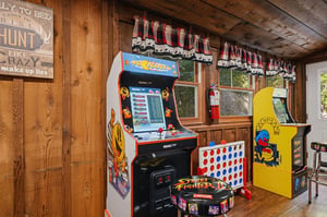 Challenge friends to arcade classics in this funfilled game room featuring vintage cabinets and Connect Four for endless entertainment.