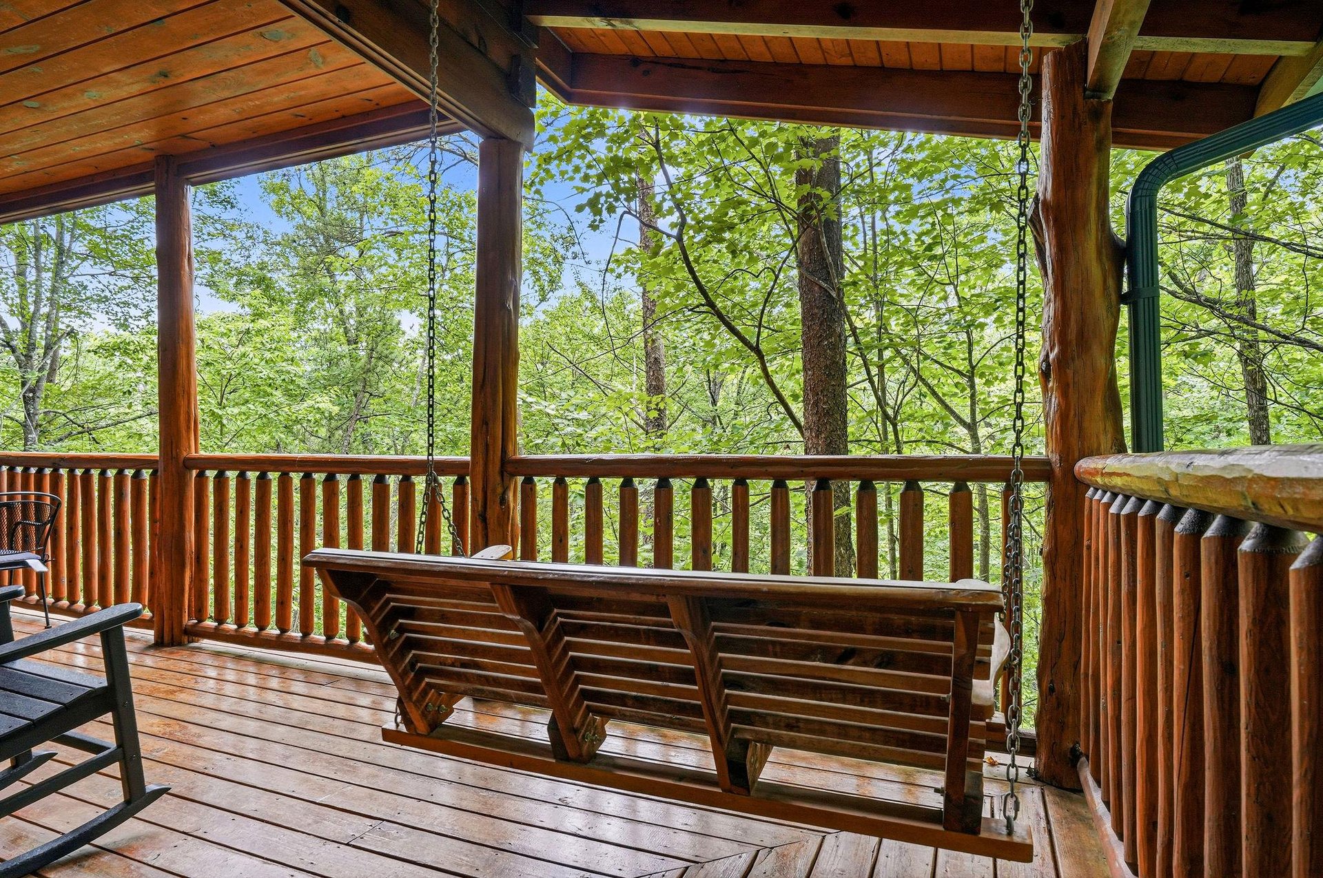 Imagine unwinding on your covered terrace, swaying on the porch swing while surrounded by tranquil forest views—your peaceful retreat awaits.