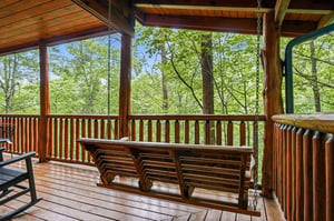 Imagine unwinding on your covered terrace, swaying on the porch swing while surrounded by tranquil forest views—your peaceful retreat awaits.