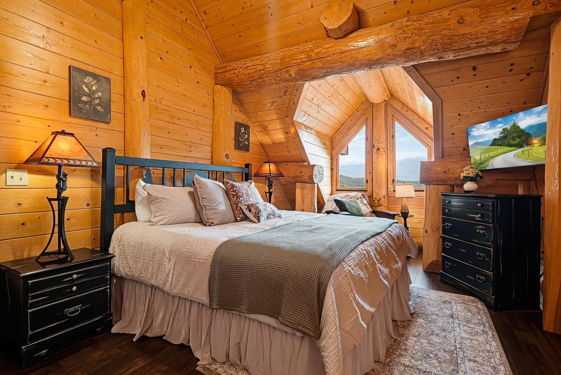 Sink into this inviting bed surrounded by warm wood walls and natural light. Wake to mountain views from your windows and enjoy your own cozy retreat.