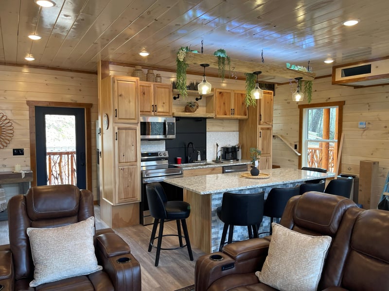 Relax in this openconcept living space with rustic charm and modern comfort. Rich leather seating and granite island create perfect gathering spots.