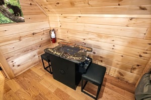 Challenge friends to retro arcade games in your cozy woodpaneled game nook, complete with classic cocktail table setup.