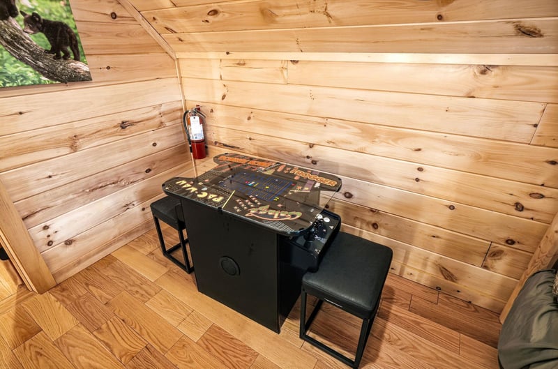 Challenge friends to retro arcade games in your cozy woodpaneled game nook, complete with classic cocktail table setup.