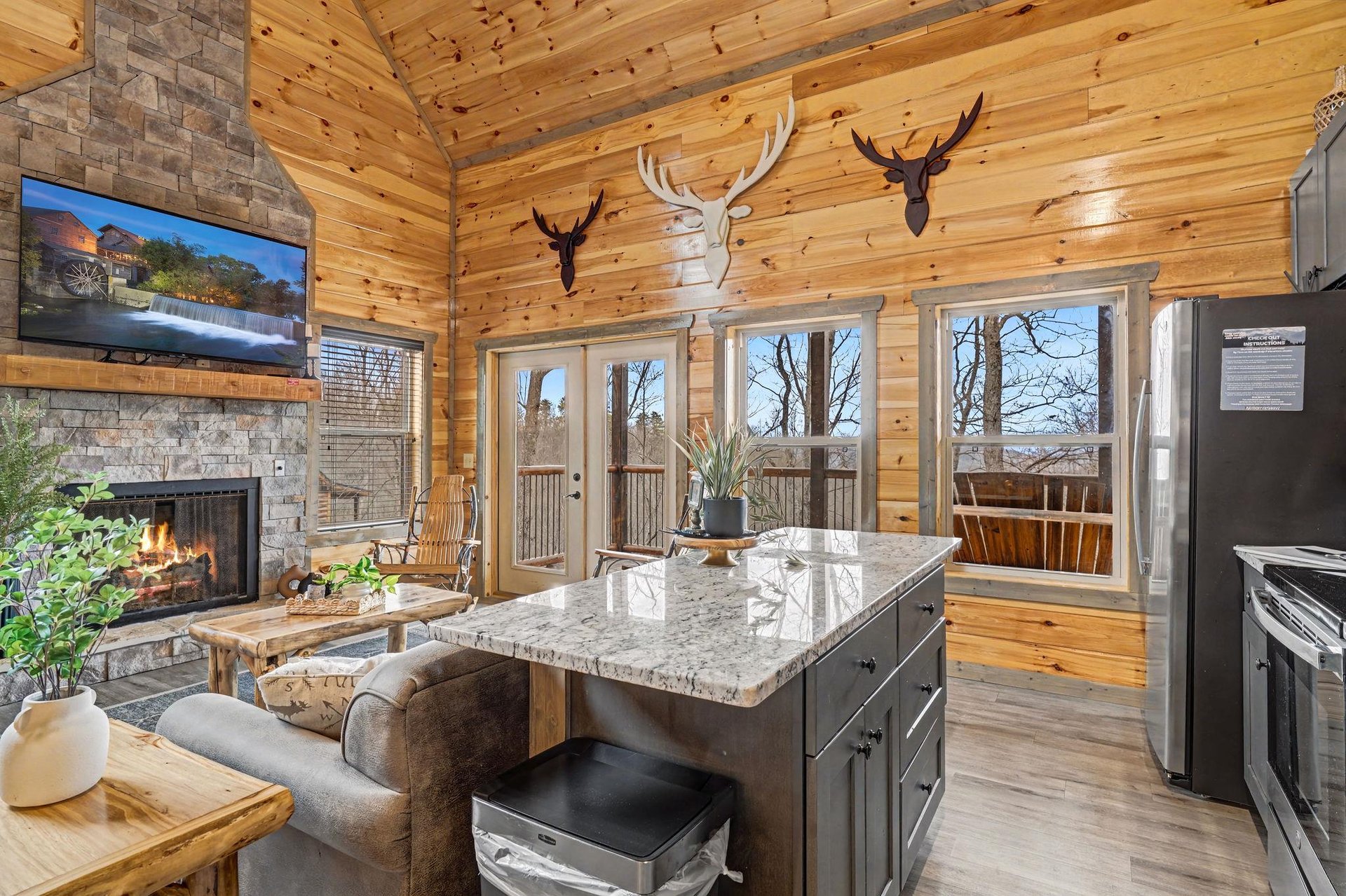 Cozy up in this stunning cabin where rustic charm meets modern comfort—crackling fireplace, granite island, and forest views await.
