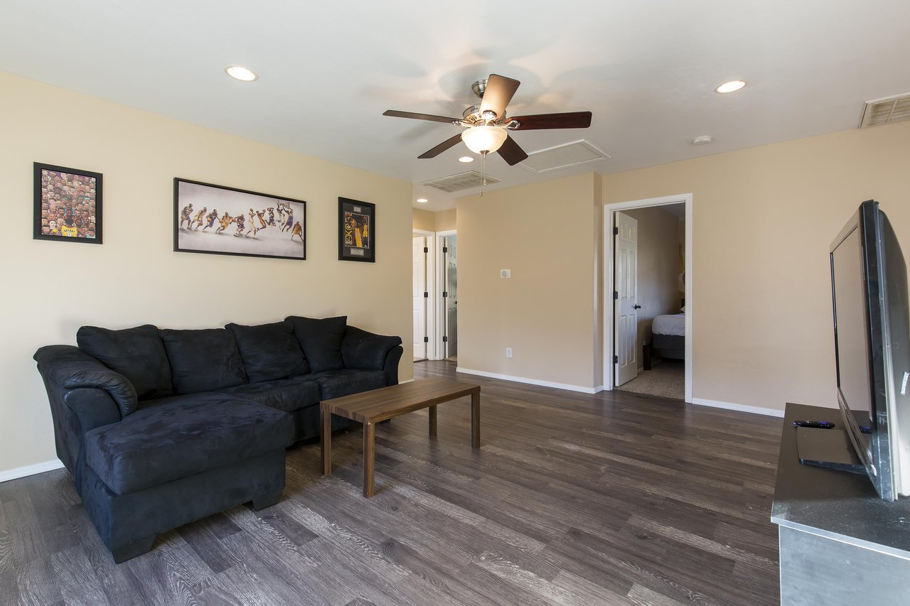 Upstairs living room with a cozy sectional couch and flatscreen TV.