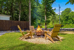 Gather around the fire pit for cozy evenings under the trees, with comfy Adirondack chairs perfect for stargazing and smores.