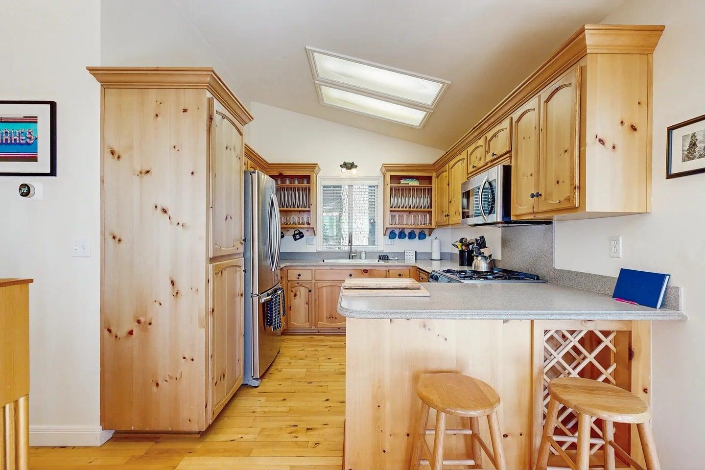 Stainless steel appliances, counter seating for 2, and kitchen essentials.