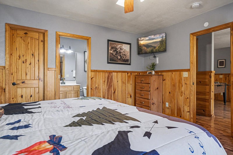 Unwind in this cozy bedroom with beautiful wood paneling, where youll drift off beneath nature artwork and wake refreshed.