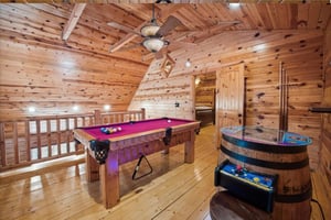 Challenge friends to pool and arcade games in your own rustic game room, complete with wood beams and mountain cabin charm.