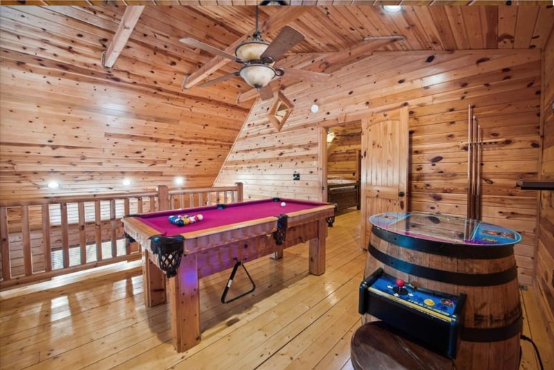 Challenge friends to pool and arcade games in your own rustic game room, complete with wood beams and mountain cabin charm.