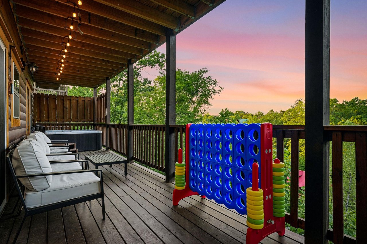 Unwind on this spacious deck featuring outdoor games and a hot tub, where sunset views create magical evenings.
