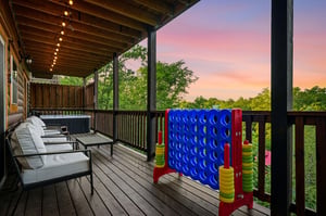 Unwind on this spacious deck featuring outdoor games and a hot tub, where sunset views create magical evenings.