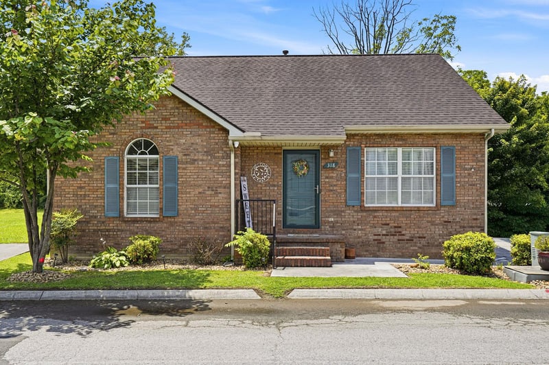 A charming brick ranchstyle home with classic shutters, a welcoming front entrance, and beautifully maintained landscaping that greets you upon arrival.