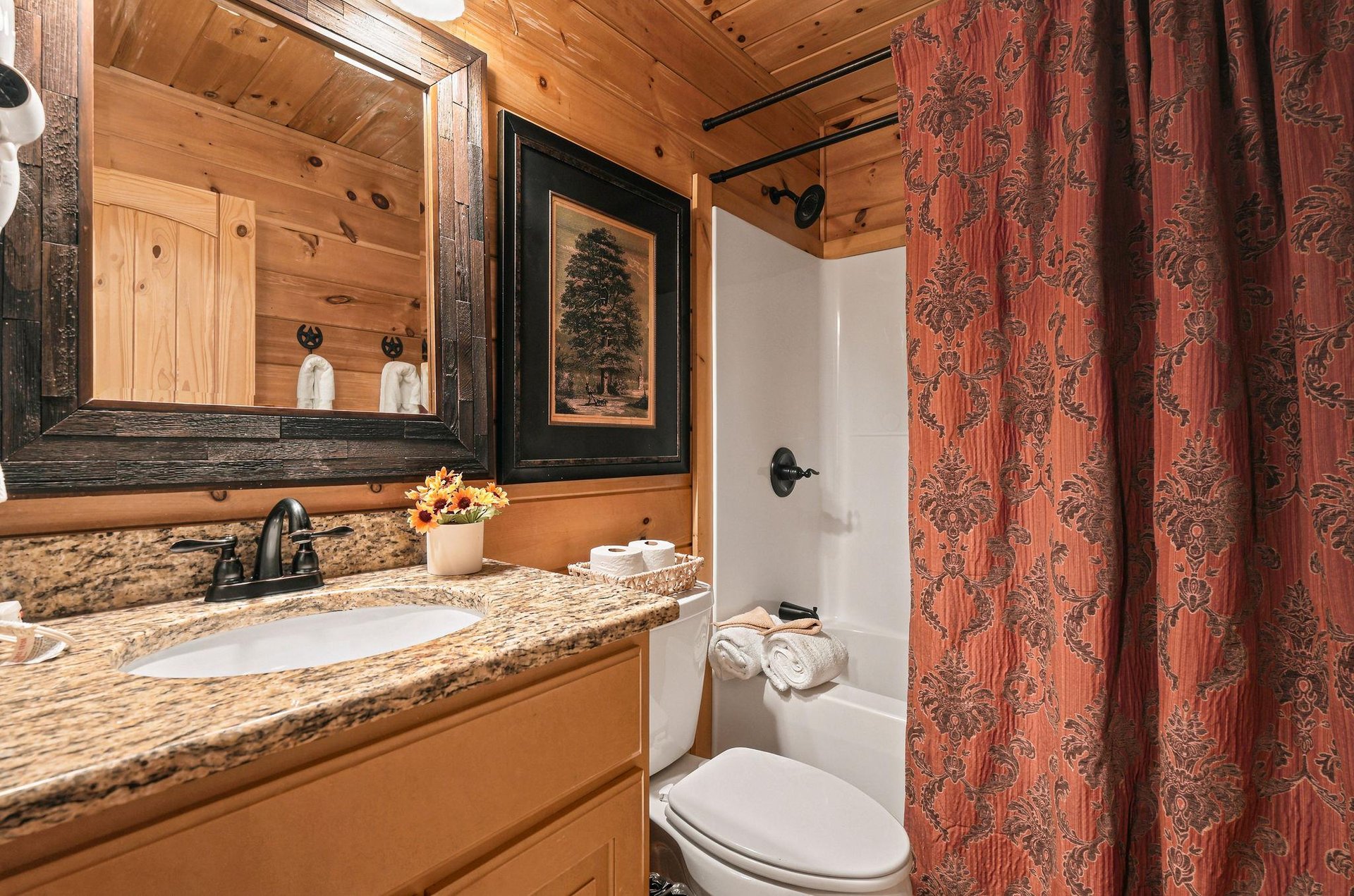 Step into your charming cabinstyle bathroom, where warm wood and rustic touches make every moment feel like a mountain retreat.