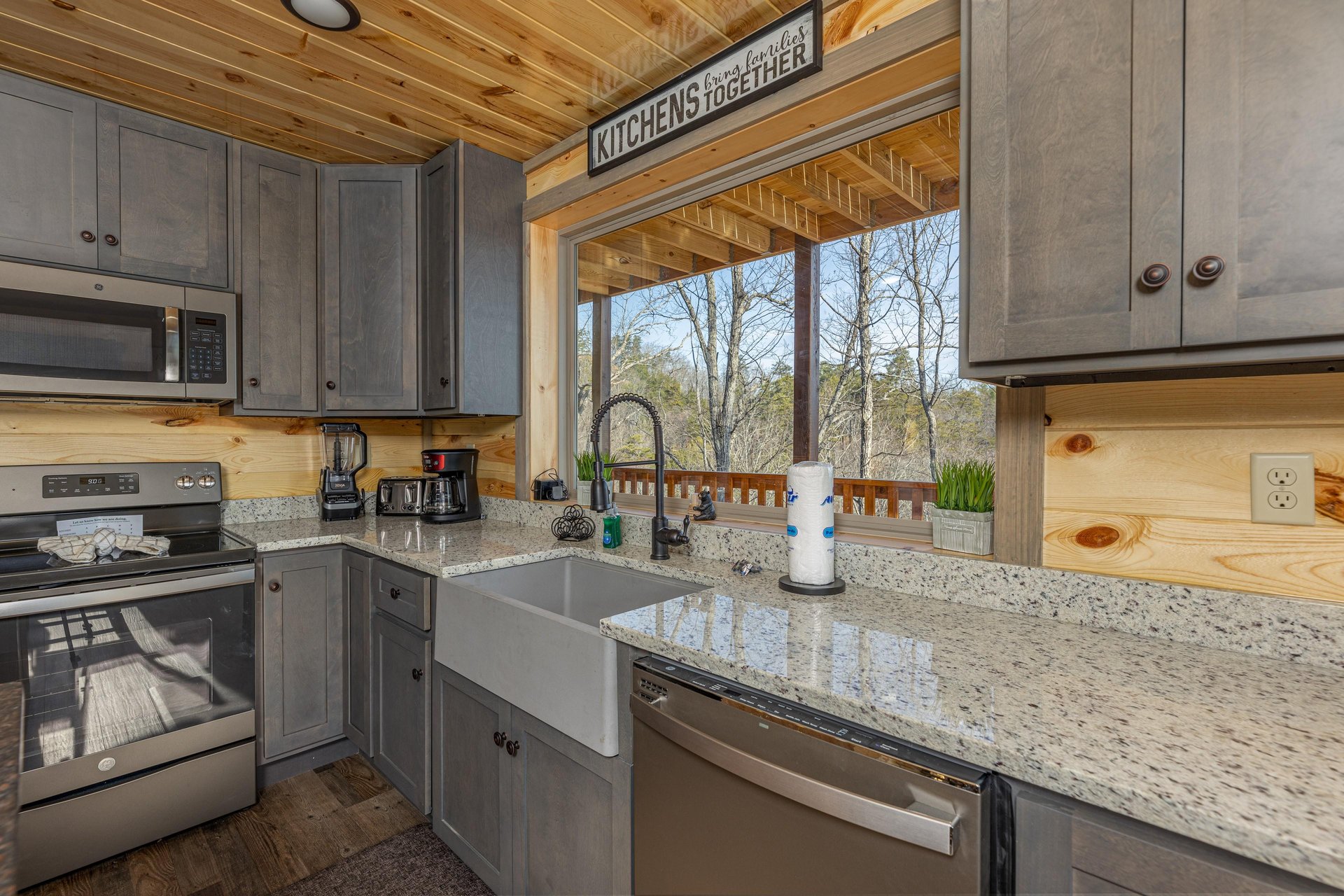 Kitchen with granite counters and a great window at Everlys Splash, a 4 bedroom cabin rental located in Pigeon Forge
