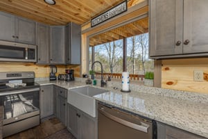Kitchen with granite counters and a great window at Everlys Splash, a 4 bedroom cabin rental located in Pigeon Forge