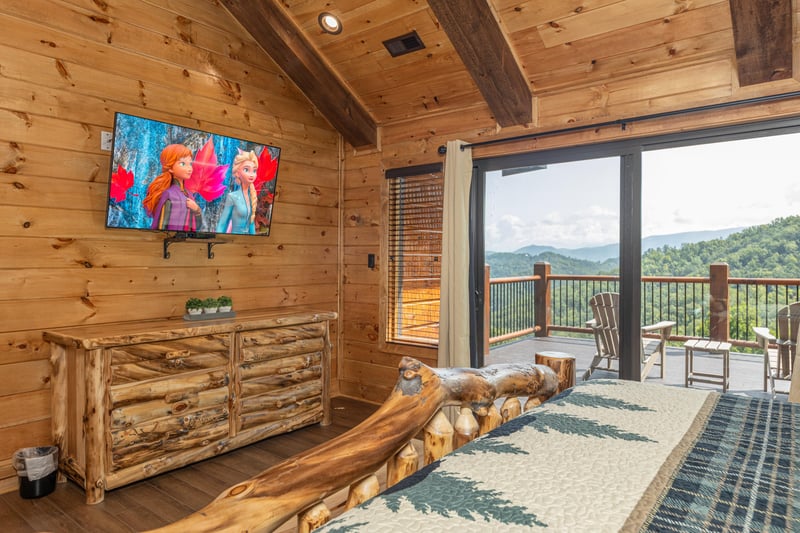 Dresser, TV, and deck access in a bedroom