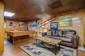 Unwind in your private game room with a billiard table, plush leather sofa, and vintage ski decor that sets the stage for cozy mountain evenings with friends and family.