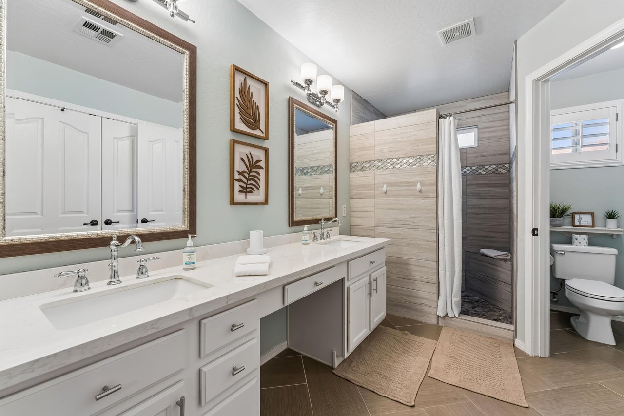 Dual vanity sinks and stand alone shower with detachable shower head.