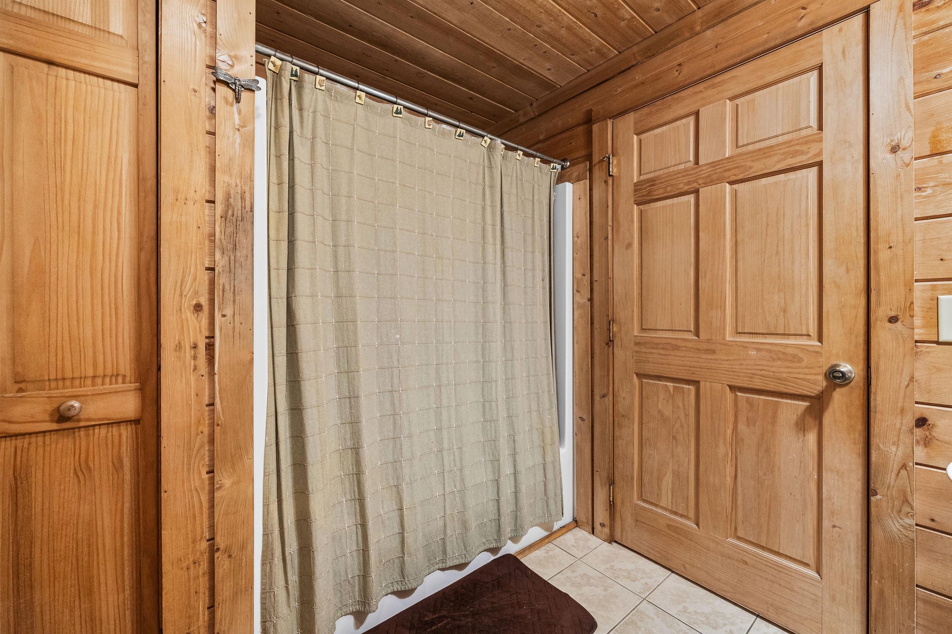 Tub and shower in a bathroom at A Beary Nice Cabin, a 2 bedroom cabin rental located in Pigeon Forge