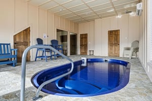 Your private indoor pool sanctuary awaits, complete with comfortable seating for relaxation between refreshing swims.