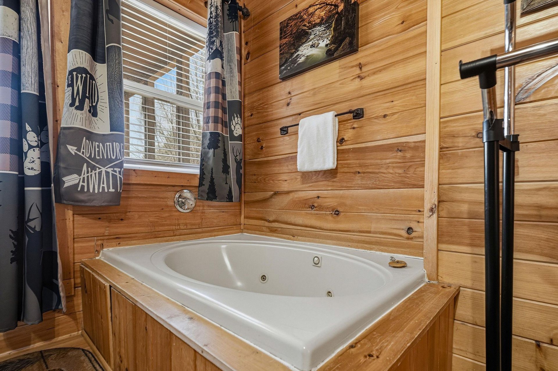 Soak your cares away in this cozy jetted tub, surrounded by warm wood walls and rustic charm for the perfect mountain retreat experience.